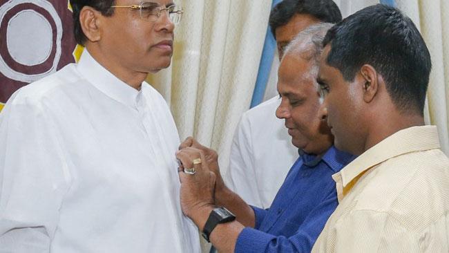 President donates financial aid to visually handicapped
