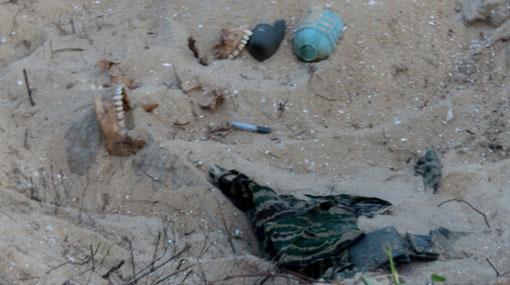Bone fragments & parts of LTTE uniforms found at Vellamullivaikal