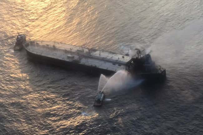 Distressed oil tanker being towed to safe waters