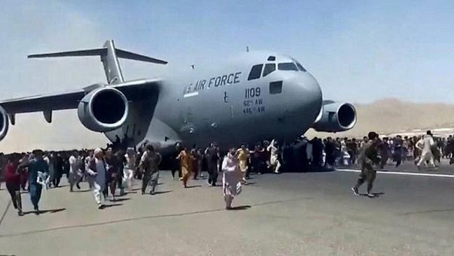 At least five dead as Afghans swarm airport to escape Taliban rule