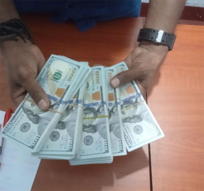 Person arrested with USD 50,000 on suspected money laundering