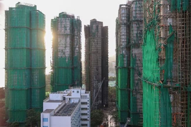 Hong Kong mourns victims of fire that killed 128 and counting
