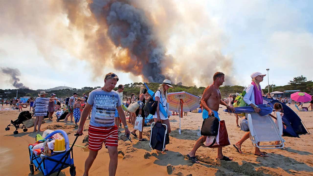 France orders evacuation of peninsula as hundreds flee wildfires by boat