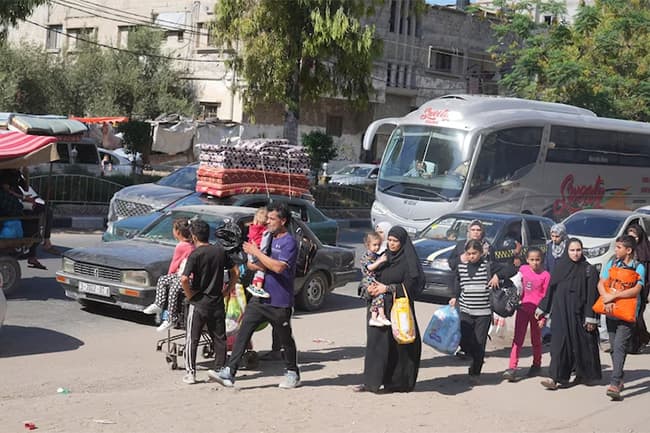 Thousands of Palestinians flee northern Gaza as Israel prepares ground offensive