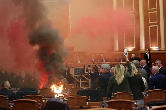 Albanian opposition protests budget in parliament with smoke bombs and fire